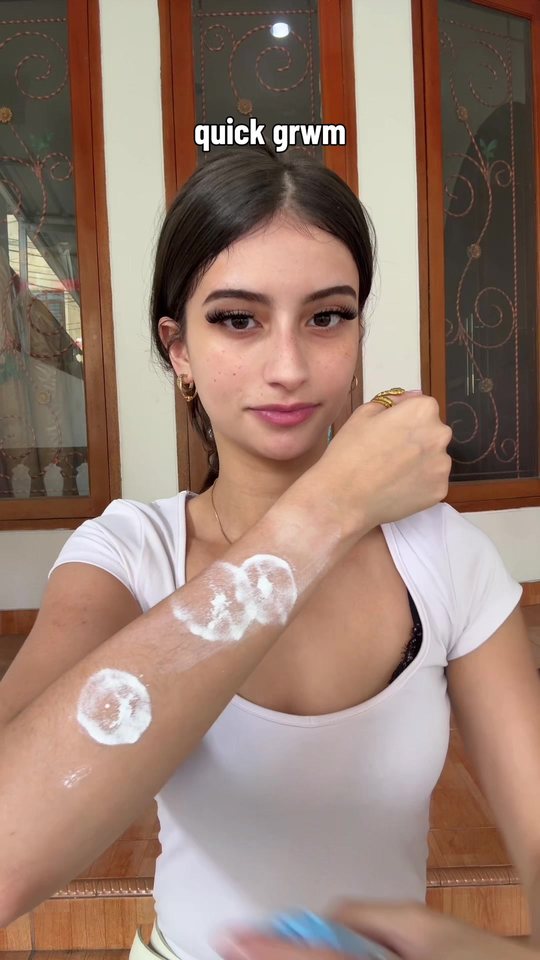 Video cover: Aisha applying body cream to her arm, captioned quick GRWM.
